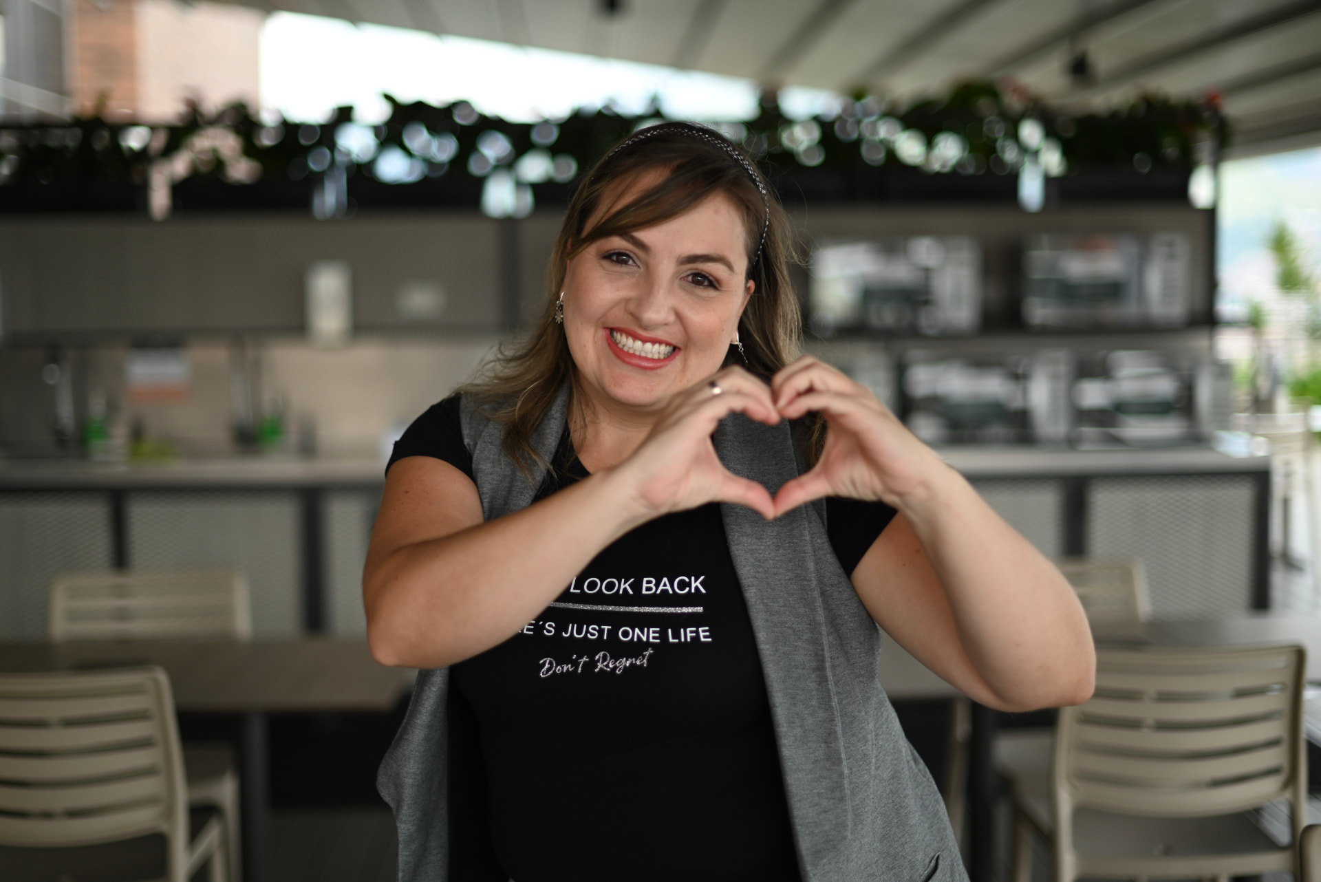 Summa team member making a heart with her hands