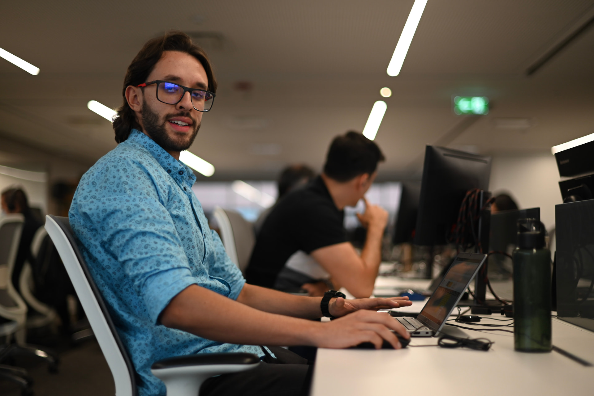 Summa team member working on a laptop at the office